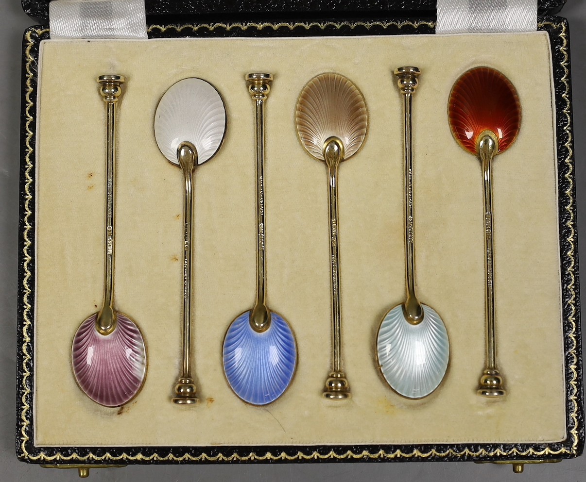 A cased set of six Elizabeth II silver and polychrome enamelled coffee spoons, Birmingham, 1960 and a cased set of six silver bean end coffee spoons.